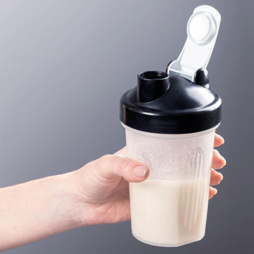 a person holding a shaker
