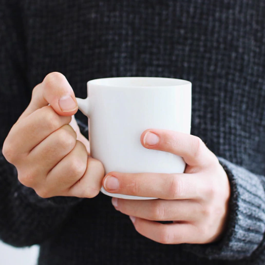 A person holding a Custom Ceramic Mug