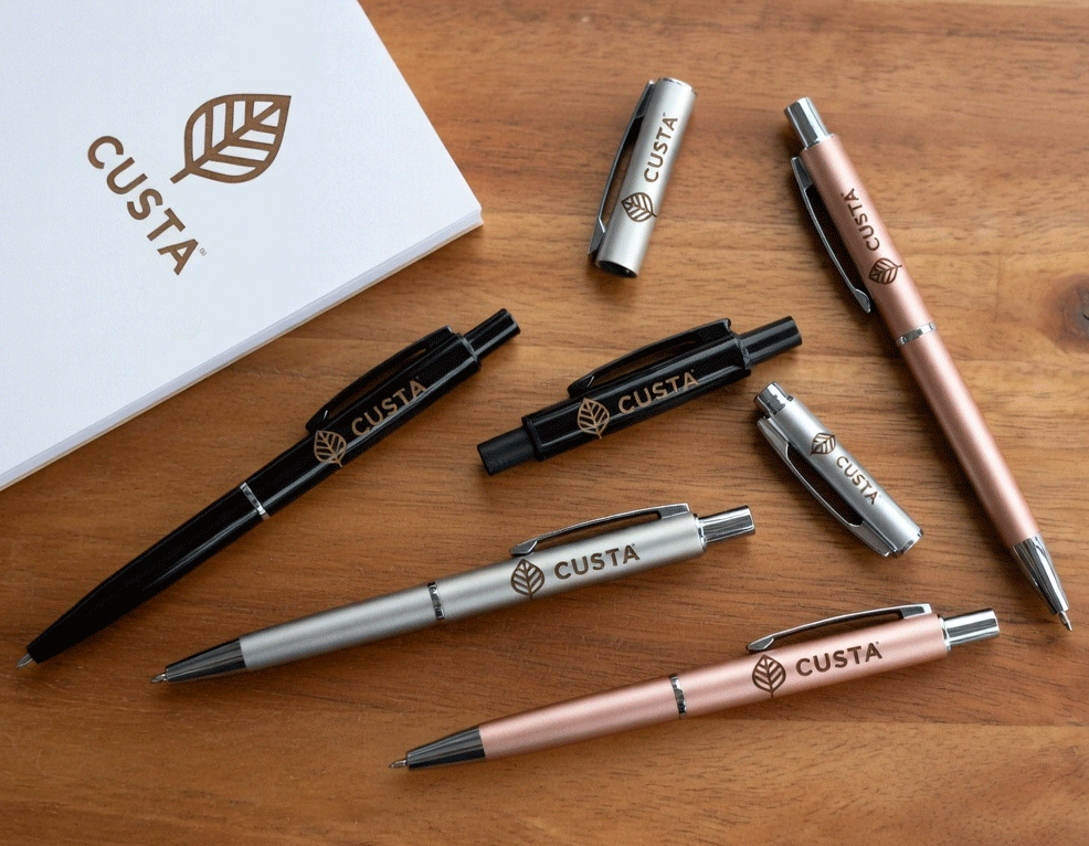 A person writing with a custom branded pen