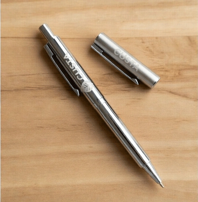 A custom branded metal pen resting on a table — CUSTA Singapore