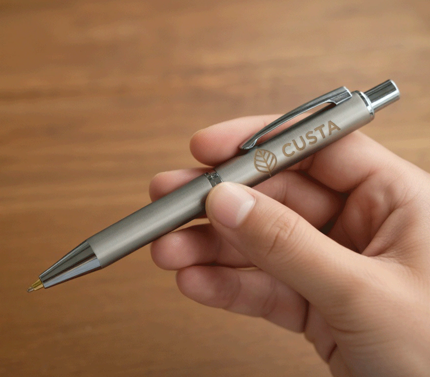 A custom aluminium pen held in hand — CUSTA Singapore