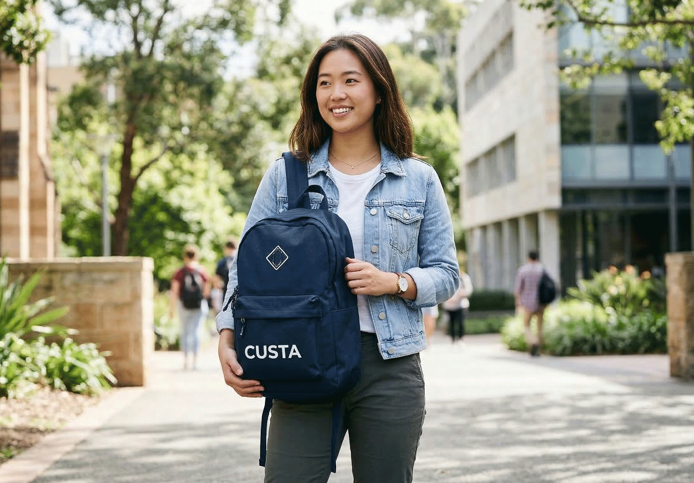 A person holding a custom printed backpack outdoors — CUSTA Malaysia